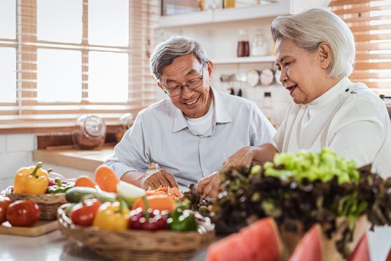 Senior couple cooking together in kitchen